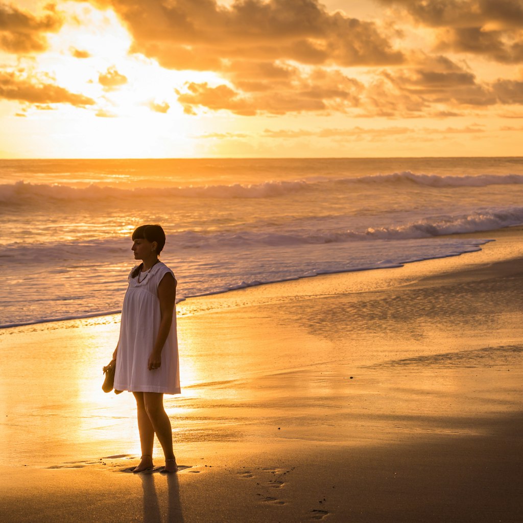 A female traveler admiring the sunset at Santa Theresa, Costa Rica