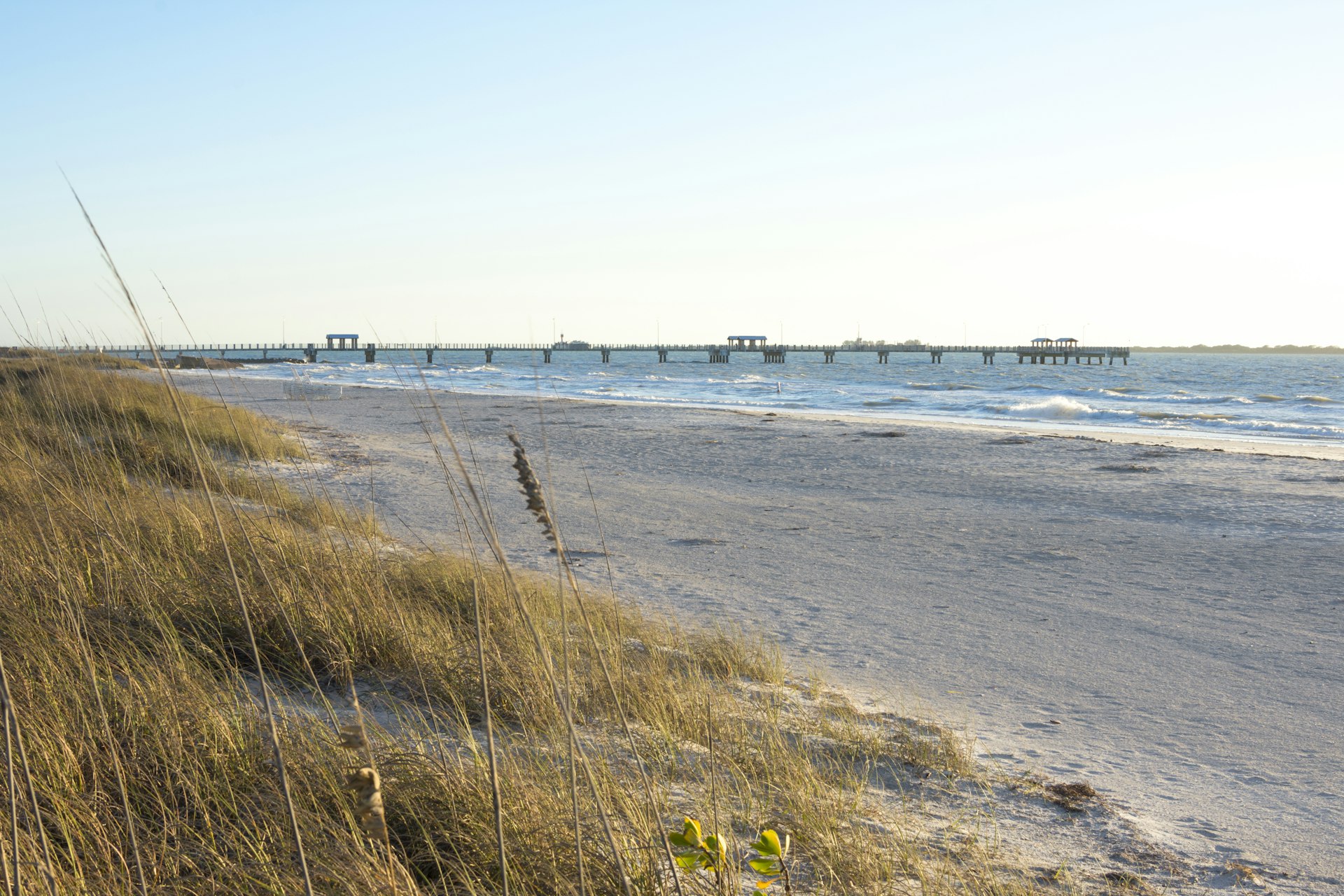 The fishing pier and beach at Fort DeSoto Park on a clear sunny day