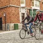 Mixed race gay men with bicycles in the city in the Temple Bar district of Dublin, Ireland