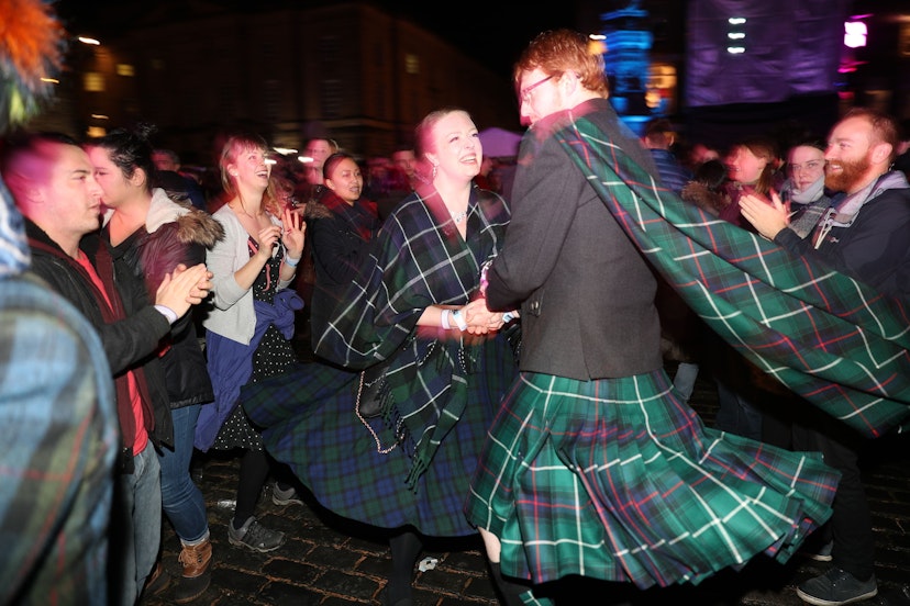 People ceilidh dance on the Royal Mile during the Hogmanay New Year celebrations in Edinburgh. (Photo by Andrew Milligan/PA Images via Getty Images)