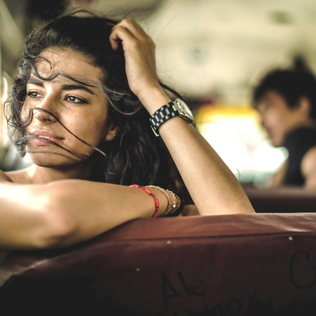 A young woman looking out of the window on a bus in Central America