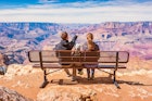 Stock photograph of a family with one child looking at view in Grand Canyon National Park, South Rim, USA on a sunny day.
