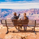 Stock photograph of a family with one child looking at view in Grand Canyon National Park, South Rim, USA on a sunny day.