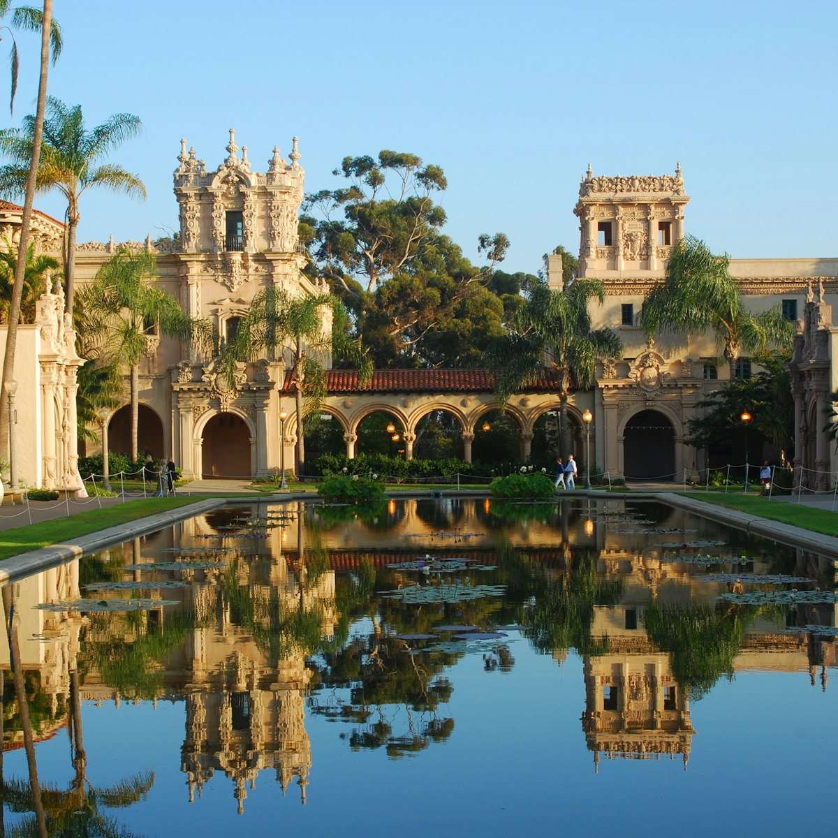 Balboa Park with buildings reflected in still water.