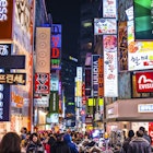 Seoul, South Korea - February 14, 2013: Crowds pass under the Myeong-Dong neon lights. The location is the premiere district for shopping in the city.