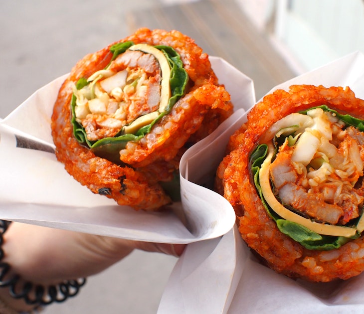 Bibimbap waffle at Hanok village, South Korea. It is composed of spicy rice rolled around a filling - pieces of meat, vegetables, cheese, and rice paper.