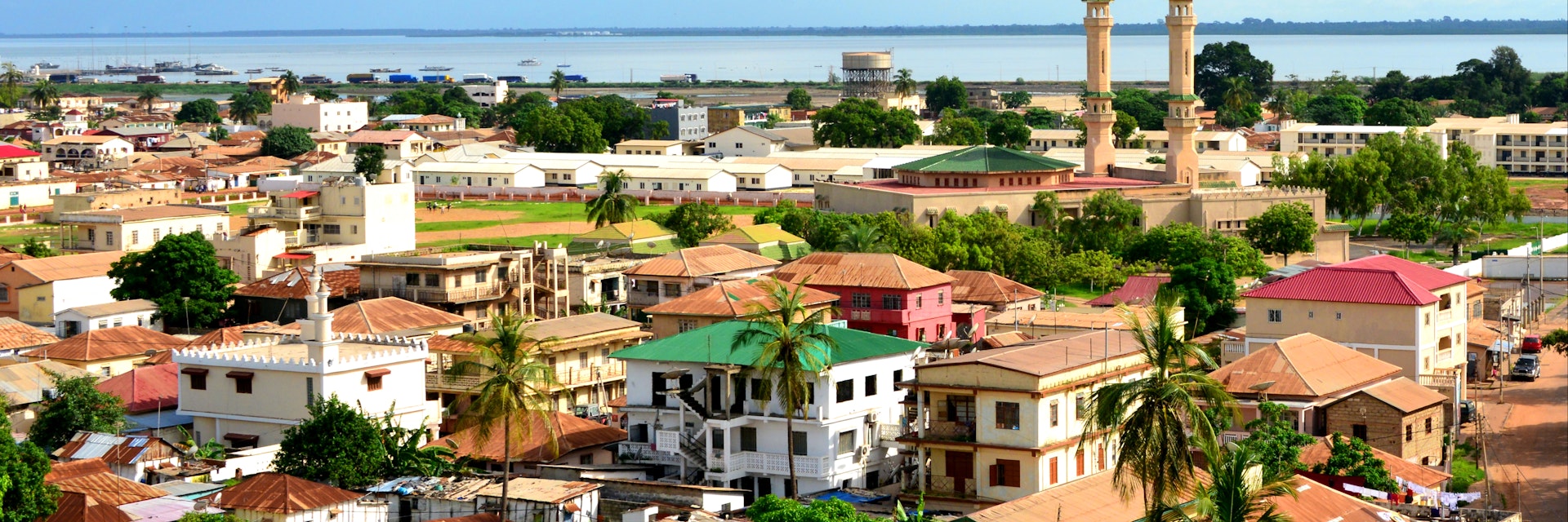 Skyline of the low-rise Gambian capital with the River Gambia and the minarets of King Fahad Mosque on the right.
