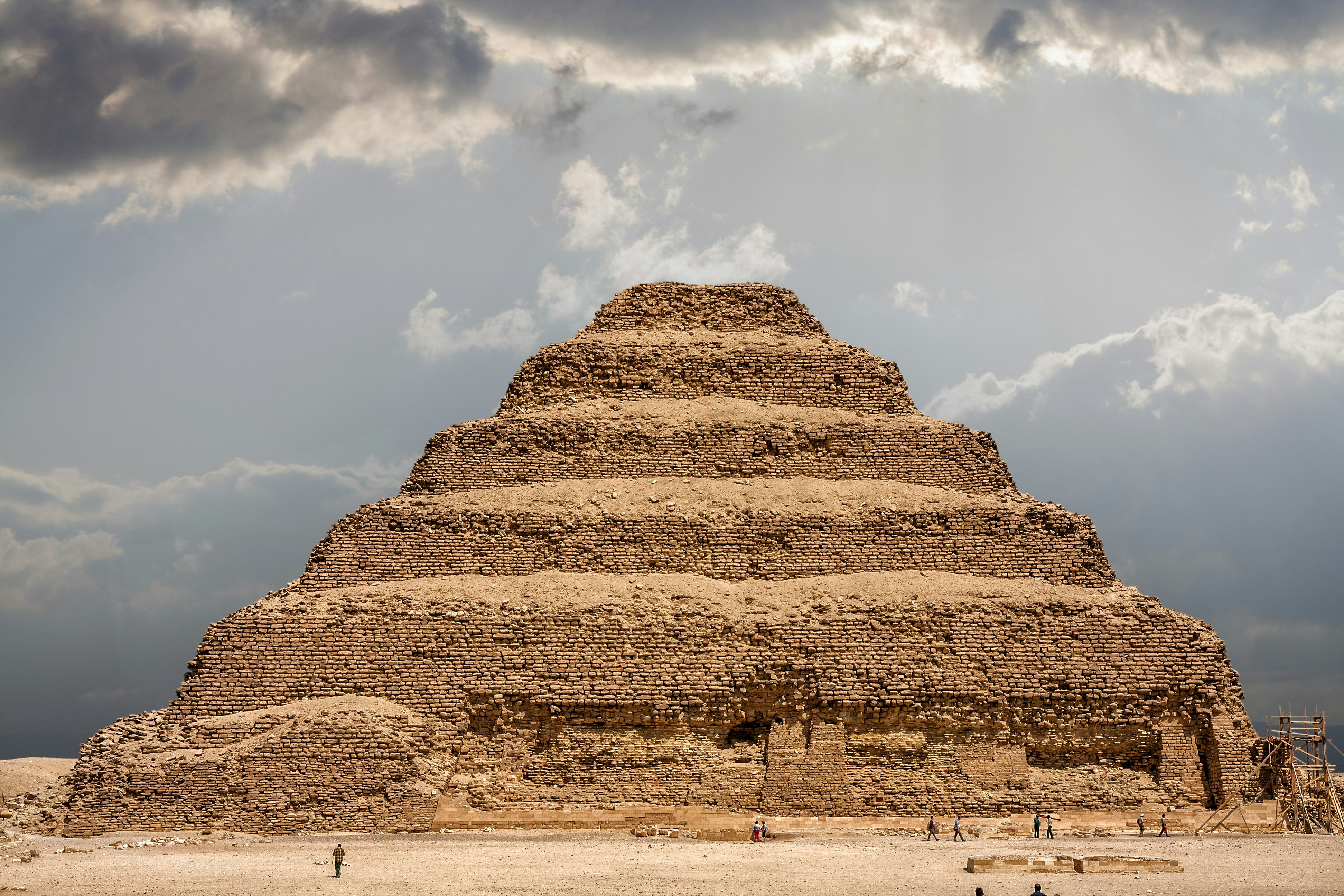 It is the most remarkable construction of the necropolis of Saqqara, south of the city of Memphis. Some tourists walk next to the pyramid..Saqqara, Egypt. March 27, 2008