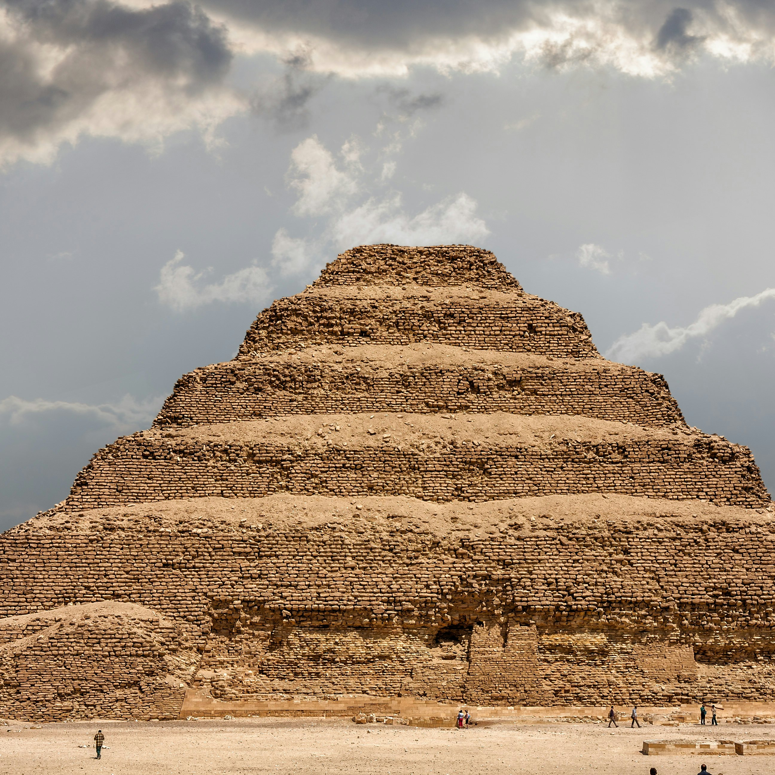 It is the most remarkable construction of the necropolis of Saqqara, south of the city of Memphis. Some tourists walk next to the pyramid..Saqqara, Egypt. March 27, 2008