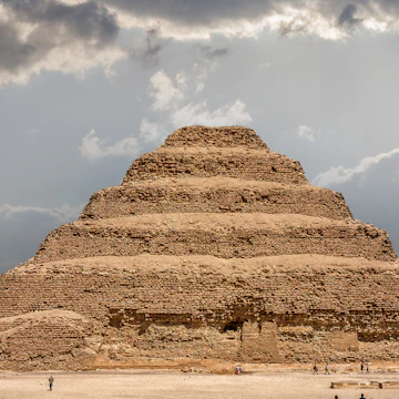 It is the most remarkable construction of the necropolis of Saqqara, south of the city of Memphis. Some tourists walk next to the pyramid..Saqqara, Egypt. March 27, 2008