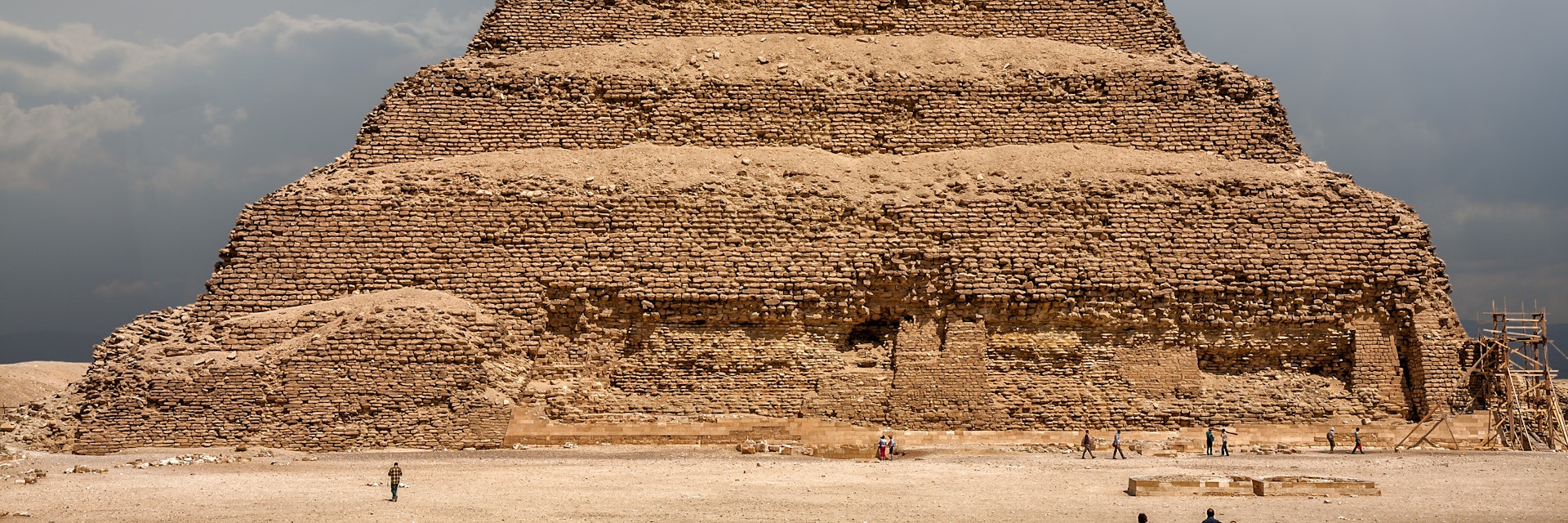 It is the most remarkable construction of the necropolis of Saqqara, south of the city of Memphis. Some tourists walk next to the pyramid..Saqqara, Egypt. March 27, 2008
