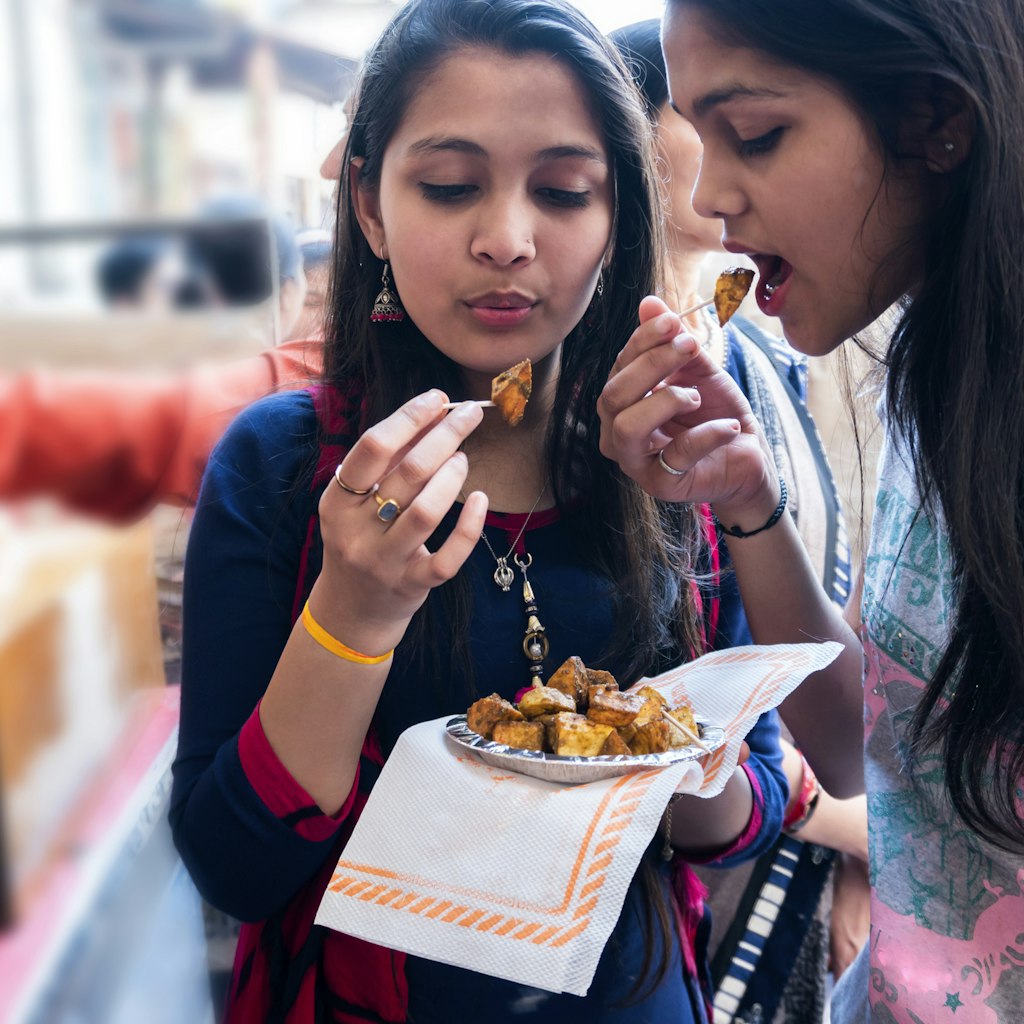 Indian teenagers friends enjoying Indian food outdoor shoot
