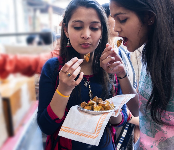 Indian teenagers friends enjoying Indian food outdoor shoot