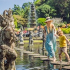 Mom and son tourists in Taman Tirtagangga, Water palace, Water park, Bali Indonesia. Traveling with children concept. Kids friendly place; Shutterstock ID 1477605794; your: Claire N; gl: 65050; netsuite: Online ed; full: Indo things to know
