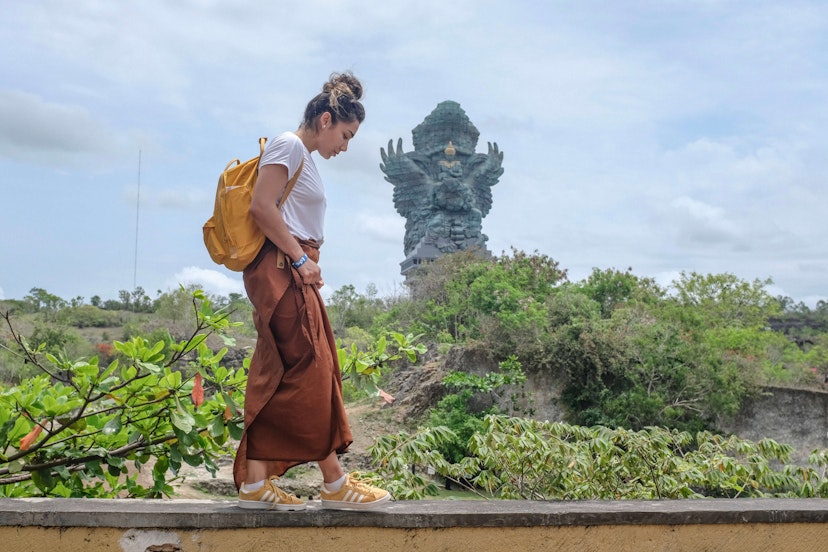 Tourist woman is visiting Garuda Wisnu Kencana Cultural Park or GWK. Vacation, tourism, balinese, Indonesian tourism, landmarks tourism in Bali.Traveling solo concept. Indonesia, Bali. 28/11/2018