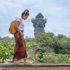Tourist woman is visiting Garuda Wisnu Kencana Cultural Park or GWK. Vacation, tourism, balinese, Indonesian tourism, landmarks tourism in Bali.Traveling solo concept. Indonesia, Bali. 28/11/2018