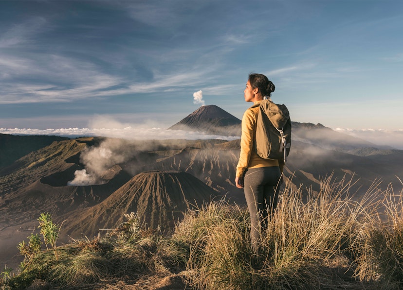 woman standing infront of mount bromo - stock photo
asia, indonesia, java, asian woman standing infront of mount bromo and mount semeru, admiring the view at sunrise