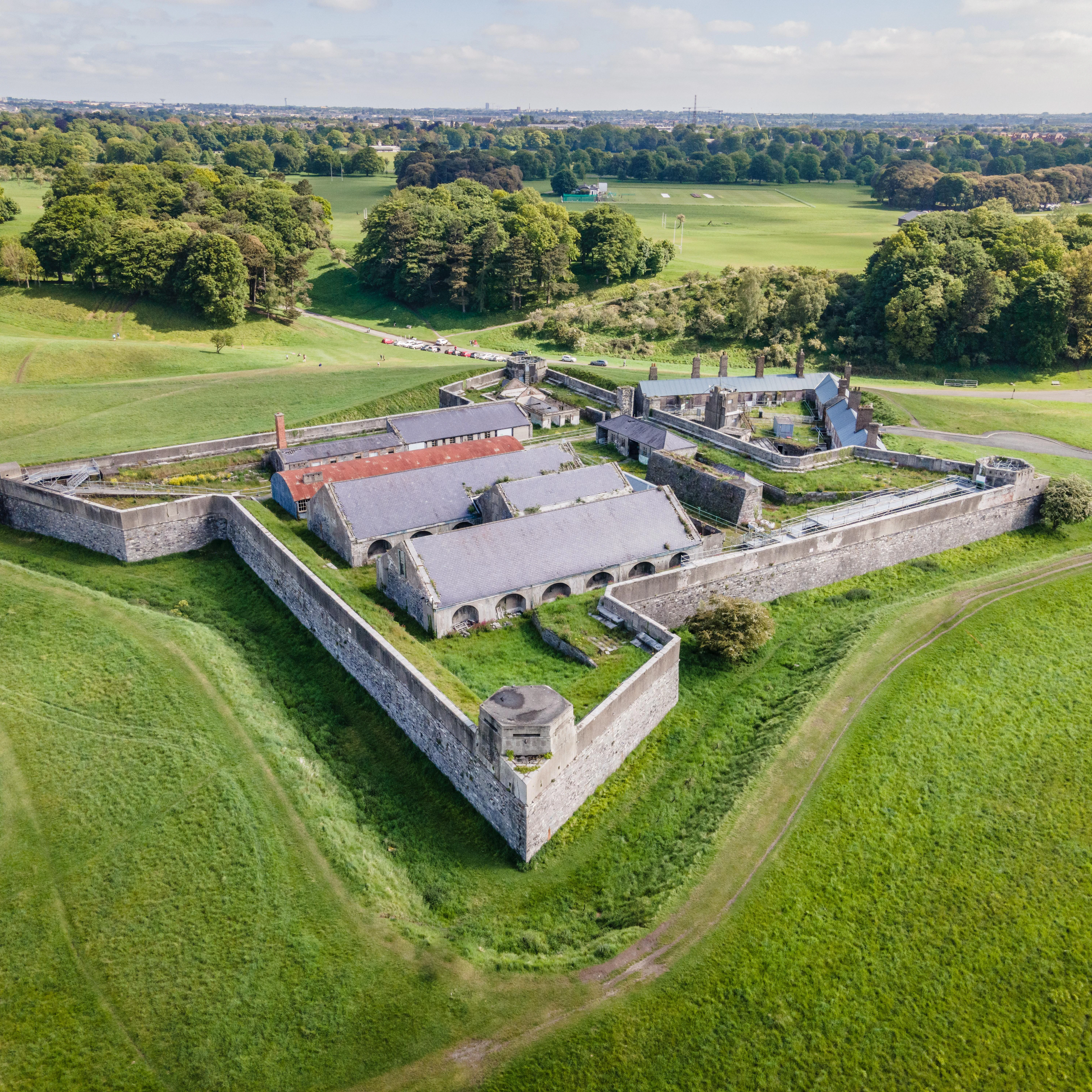 Drone aerial view over the old magazine fort in Phoenix Park, Dublin, on a bright sunny day with green grassy slopes all around
Magazine Fort