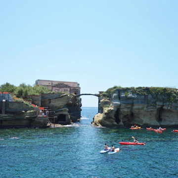 Sunbathers relax by the Gaiola Island, The Underwater Park of Gaiola, a protected marine area.Posillipo.Naples.Italy.