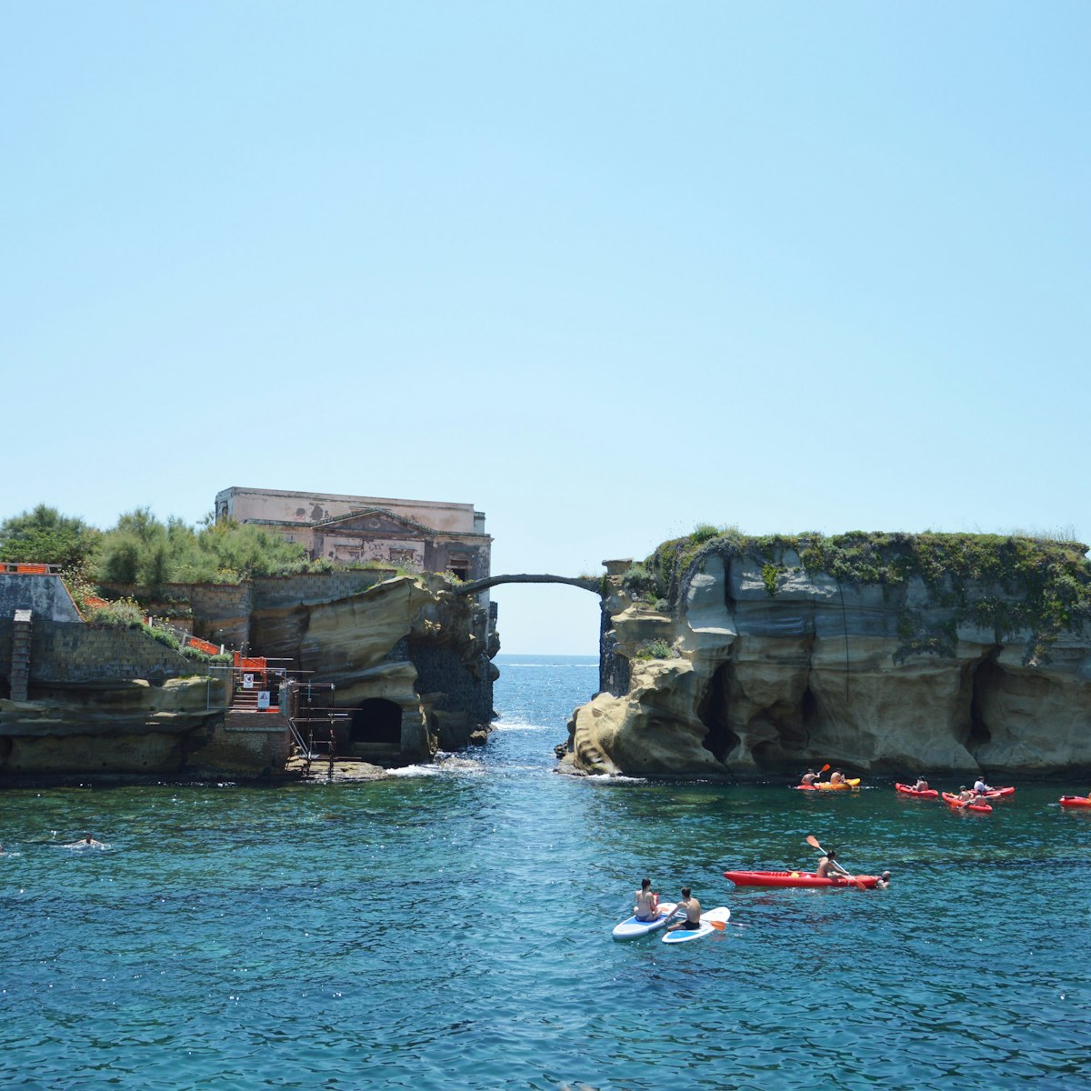 Sunbathers relax by the Gaiola Island, The Underwater Park of Gaiola, a protected marine area.Posillipo.Naples.Italy.