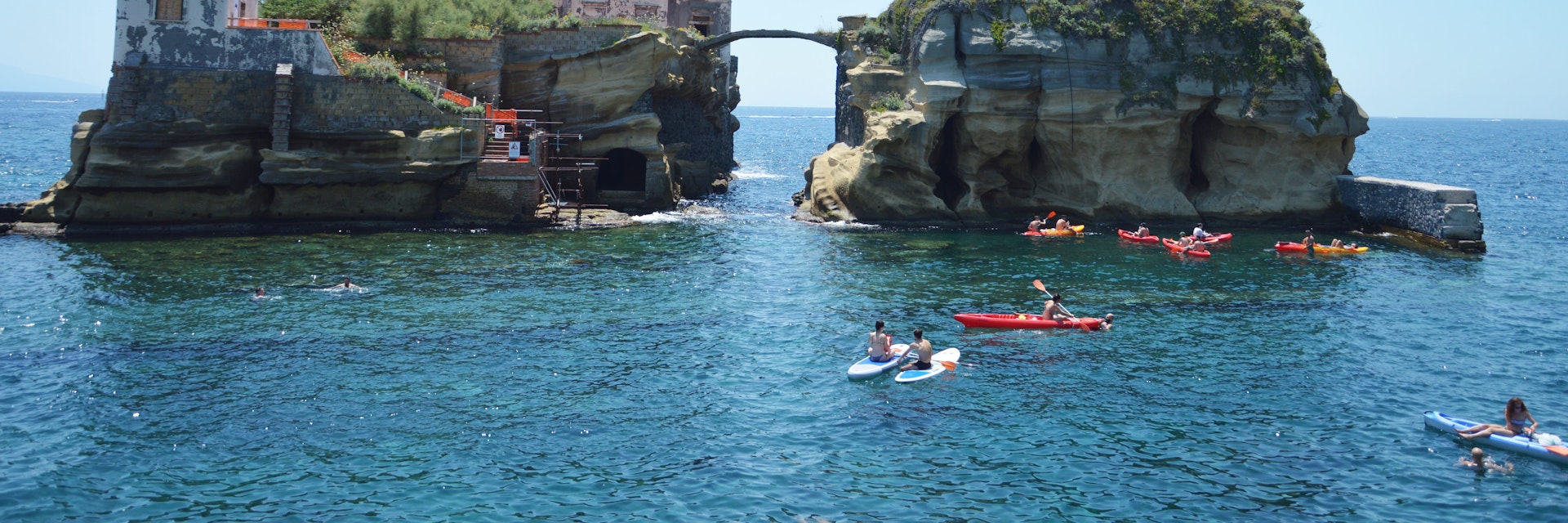 Sunbathers relax by the Gaiola Island, The Underwater Park of Gaiola, a protected marine area.Posillipo.Naples.Italy.