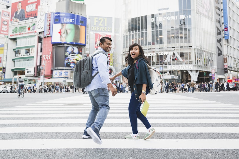 Asian travelers from Indonesia running at Shibuya crossing which is the world famous place for one of the most busiest crossing in the world.