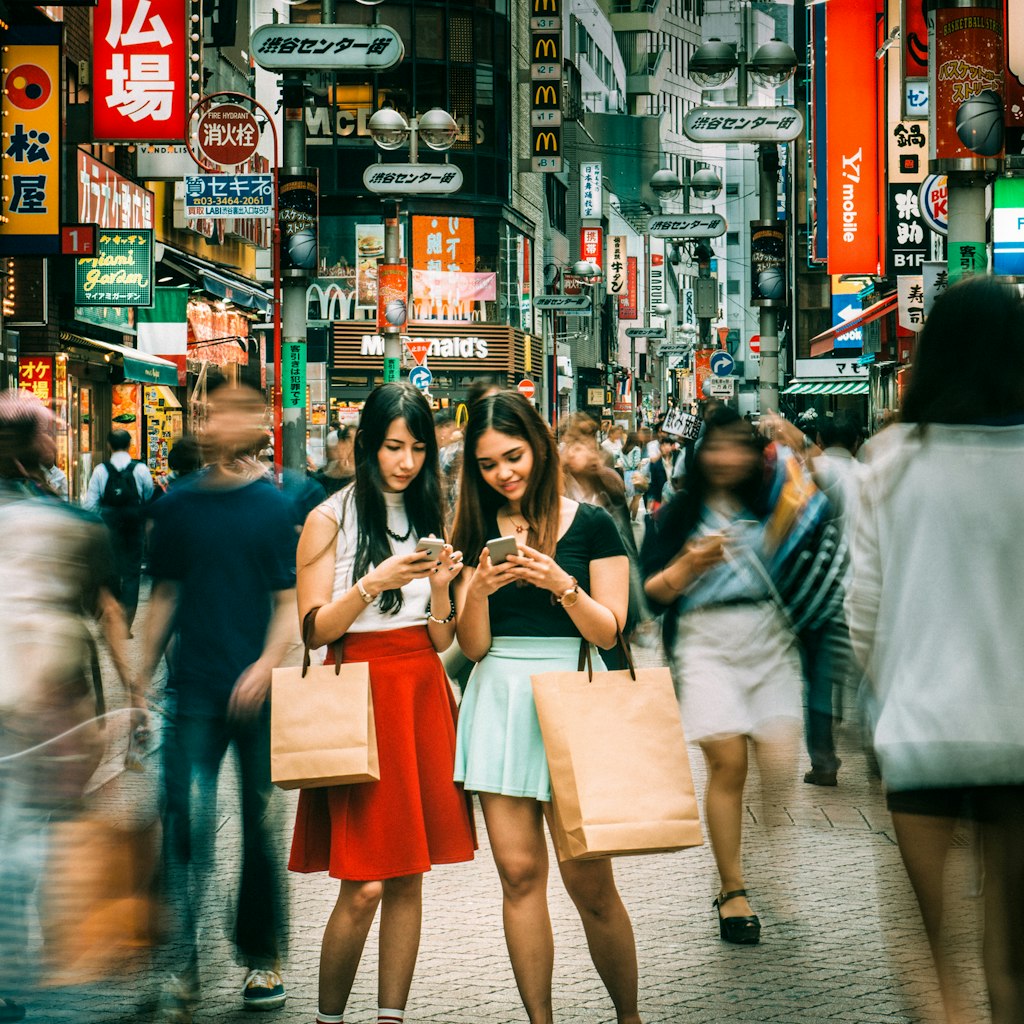 Japanese girlfriends hanging out on Shibuya streets of Tokyo. Japan.