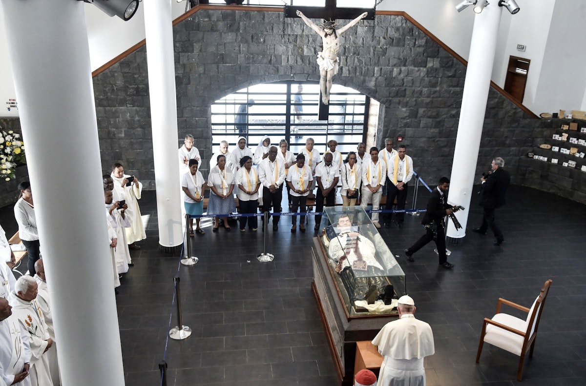 Pope Francis makes a prayer as he visits the mausoleum of Jacques-Desire Laval in Port Louis, Mauritius, on September 9, 2019, on the final stop of an Africa tour. - Pope Francis visit three-nation tour of Indian Ocean African countries hard hit by poverty, conflict and natural disaster. Francis' visit coincides with the 155th anniversary of the death of Father Jacques Desire Laval, a French priest who died in Mauritius in 1864 and was beatified in 1979. (Photo by TIZIANA FABI / AFP)        (Photo credit should read TIZIANA FABI/AFP via Getty Images)