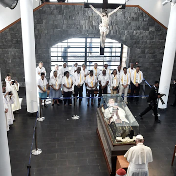 Pope Francis makes a prayer as he visits the mausoleum of Jacques-Desire Laval in Port Louis, Mauritius, on September 9, 2019, on the final stop of an Africa tour. - Pope Francis visit three-nation tour of Indian Ocean African countries hard hit by poverty, conflict and natural disaster. Francis' visit coincides with the 155th anniversary of the death of Father Jacques Desire Laval, a French priest who died in Mauritius in 1864 and was beatified in 1979. (Photo by TIZIANA FABI / AFP) (Photo credit should read TIZIANA FABI/AFP via Getty Images)