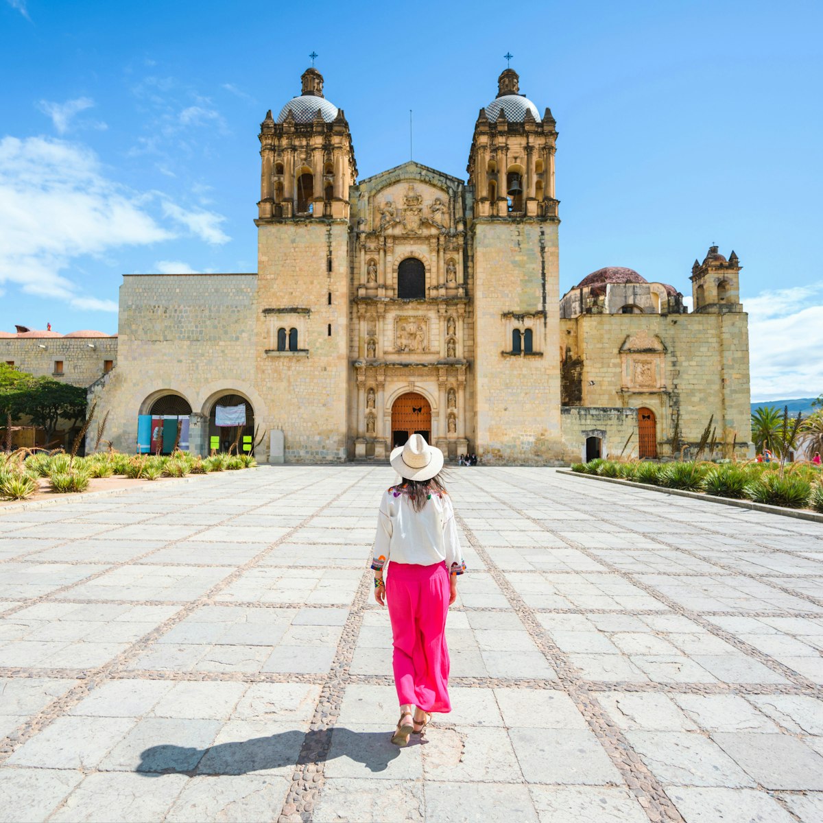 A woman walking toward the Church of Santo Domingo de Guzman, Oaxaca, Mexico.