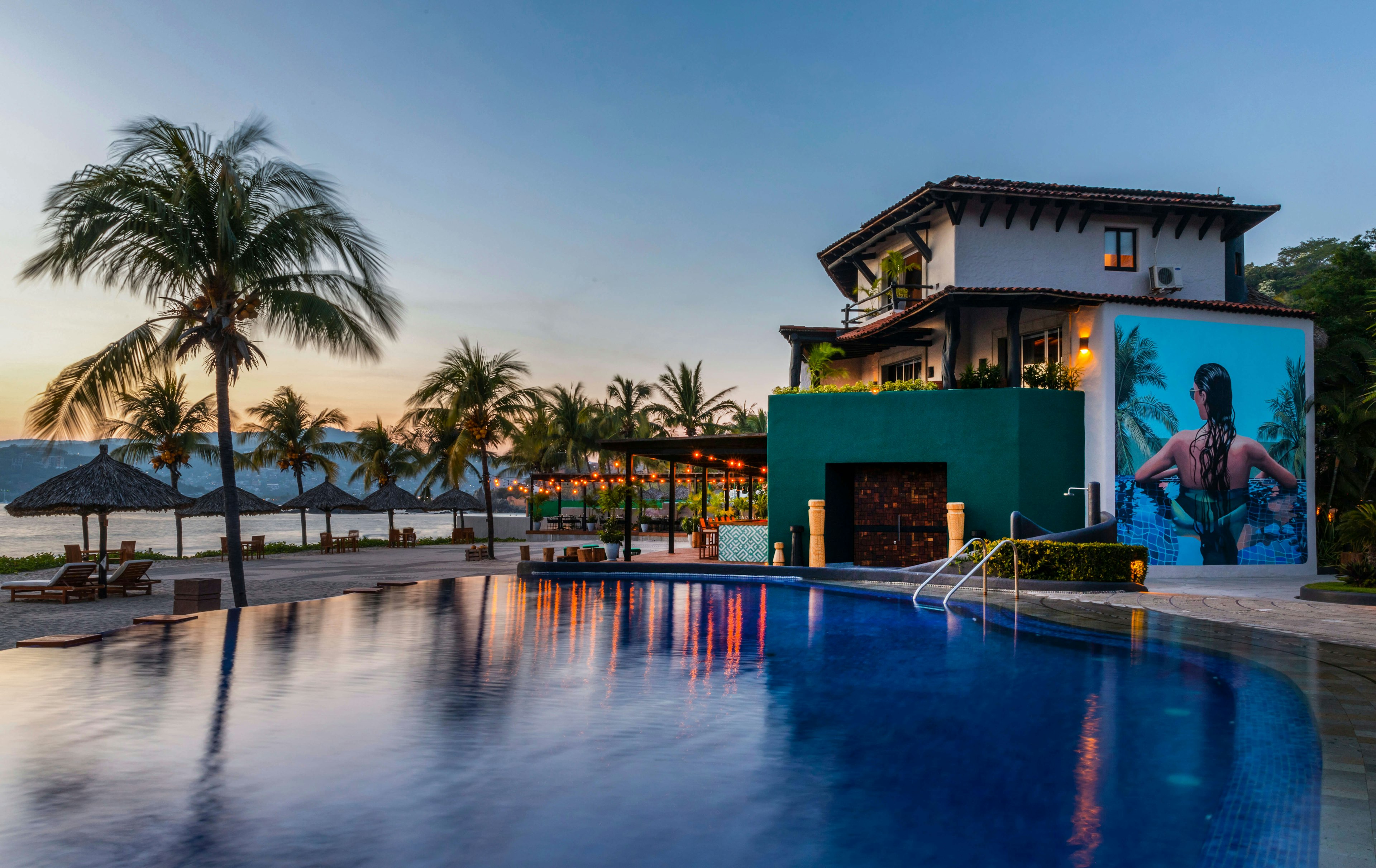 The resort and pool at the Thompson Zihuatanejo at sunset