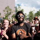 Smiling people in the front row of the crowd at a concert in Minneapolis