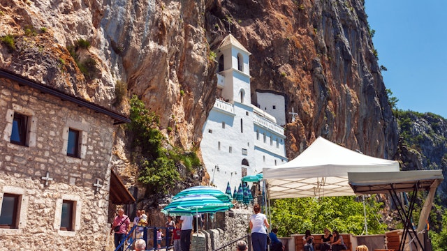 Danilovgrad, Montenegro - June 4, 2012: Tourists visit to Ostrog - Serbian Orthodox monastery in Montenegro, located in mountains 15 km from Danilovgrad town. Founded in the XVII century.