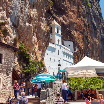 Danilovgrad, Montenegro - June 4, 2012: Tourists visit to Ostrog - Serbian Orthodox monastery in Montenegro, located in mountains 15 km from Danilovgrad town. Founded in the XVII century.