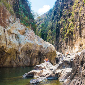 Somoto Canyon, Nicaragua. Man in the distance sitting in a stone contemplating the peaceful stream of water flowing through the rock mountains. Beautiful dry summer natural scenery.;
Monumento Nacional Cañon de Somoto
Shutterstock ID 1822814987; your: Bridget Brown; gl: 65050; netsuite: Online Editorial; full: POI Image Update