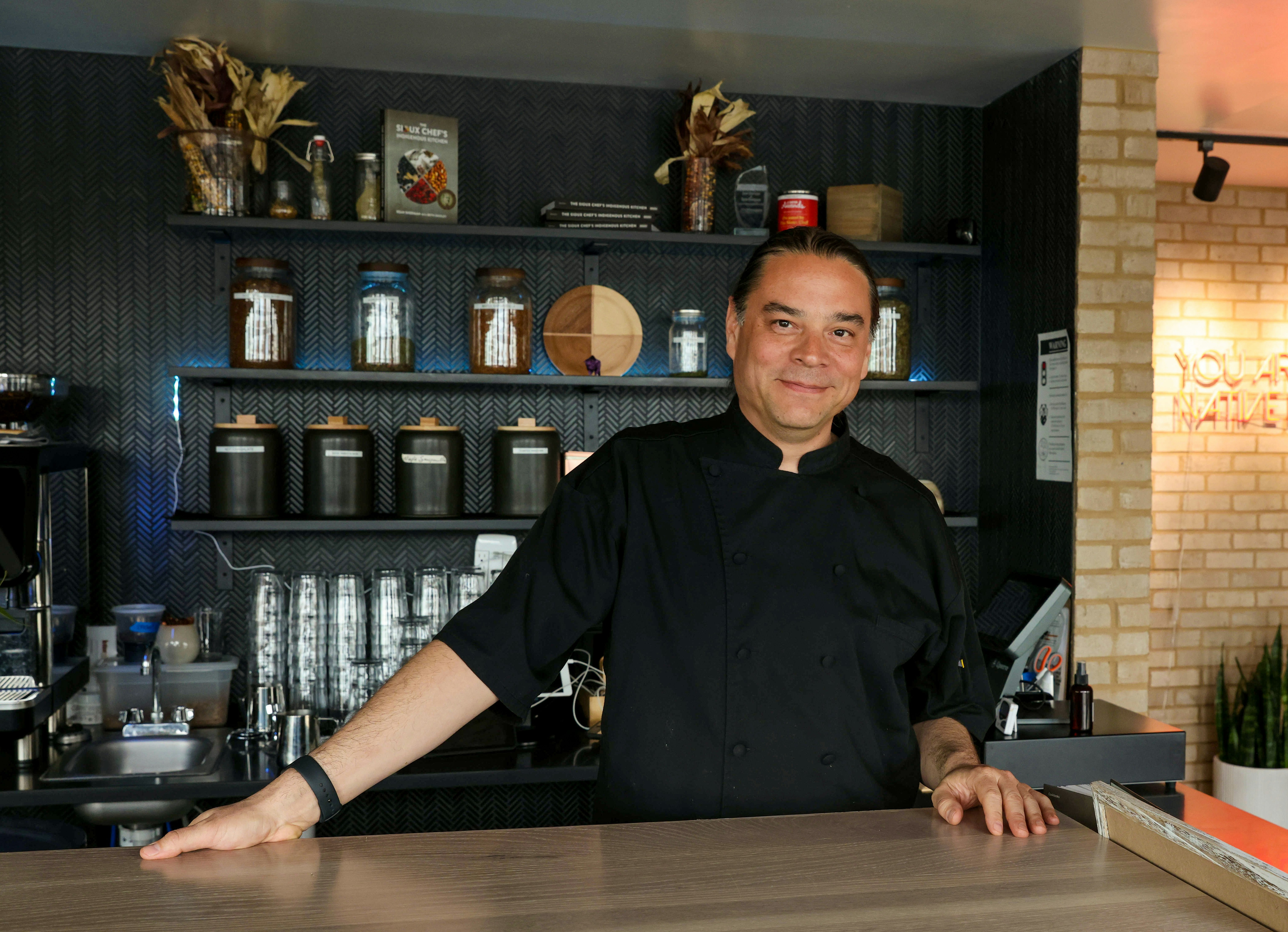 Chef and co-owner, Sean Sherman at front desk of  Owamni.