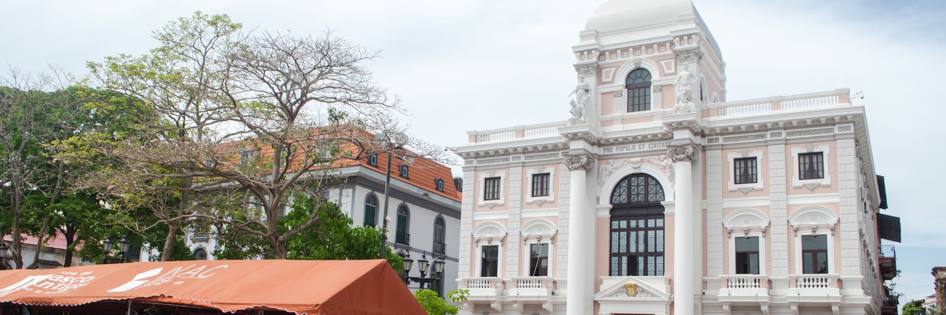 Panama City, Panama - May 19, 2019: Two historical buildings of the Old Panama City.  Panama Canal Museum can be seen on the left; on the right stands the Municipal Palace (white building). The Museum of History of Panama (Spanish: Museo de Historia de Panamá) is a history museum located on the ground floor of the Municipal Palace of Panama City.