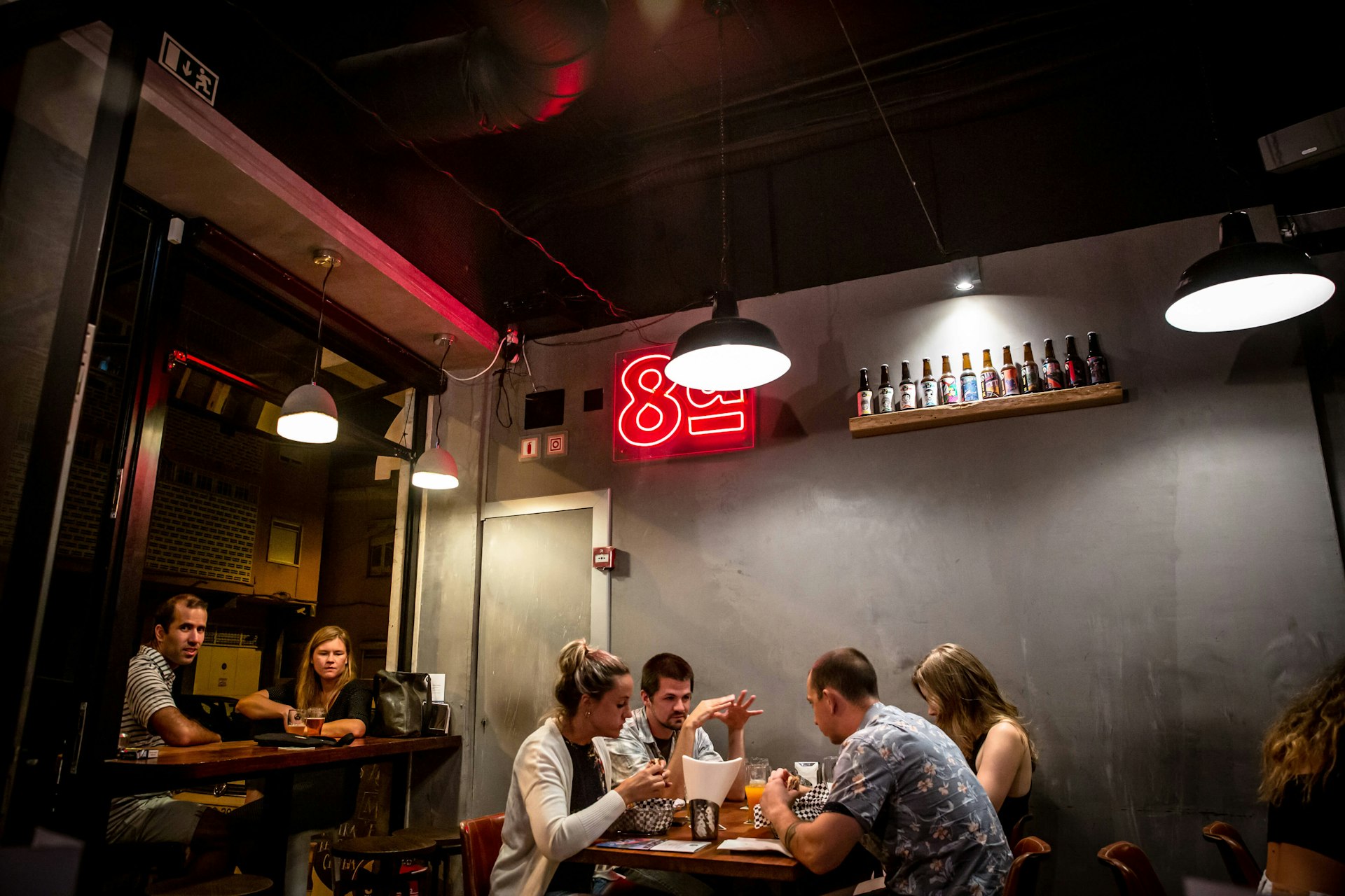 Customers relax at tables inside at the Taproom Oitava Colina in the Marvila district of Lisbon, Portugal