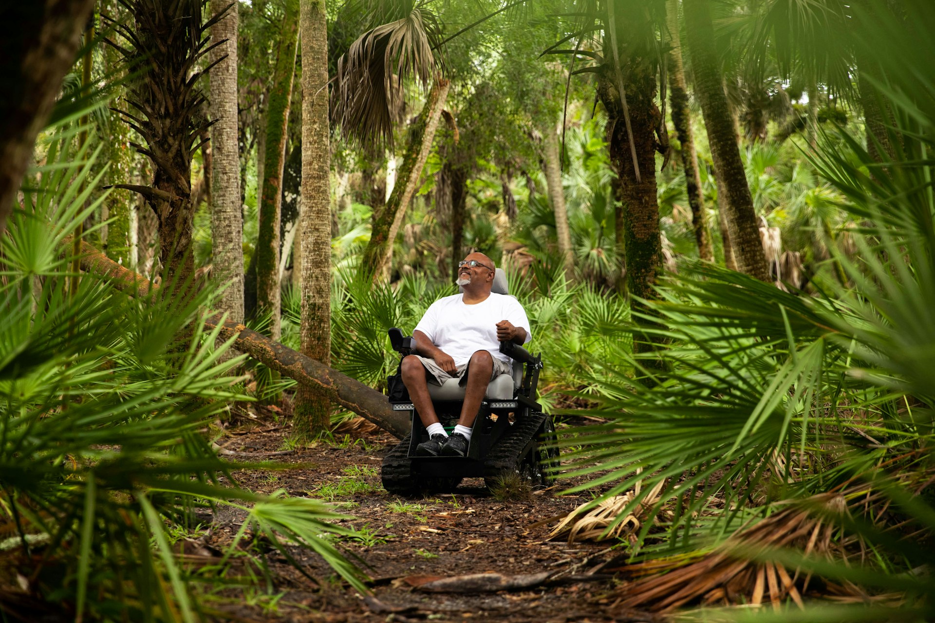 A man in a wheelchair in the woods at Myakka River State Park, Florida