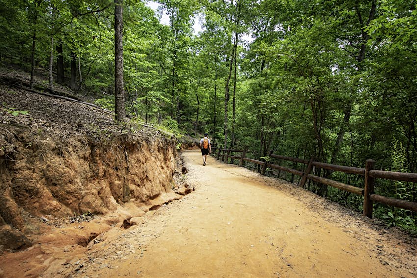 A male hiker descends into the canyon via the hiking trail at Providence Canyon State Park 