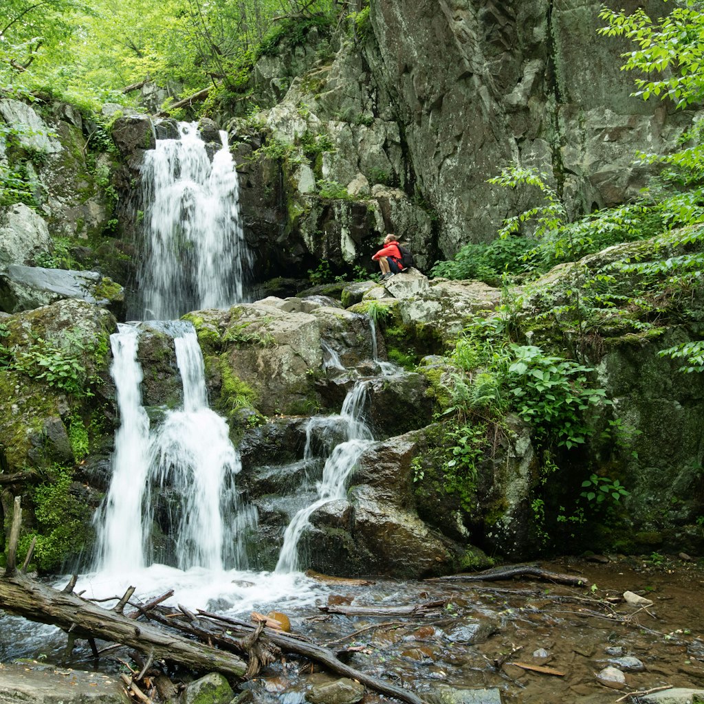 Man exploring Doyles river falls, Shenandoah National Park, Virginia, USA - stock photo