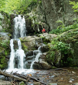 Man exploring Doyles river falls, Shenandoah National Park, Virginia, USA - stock photo