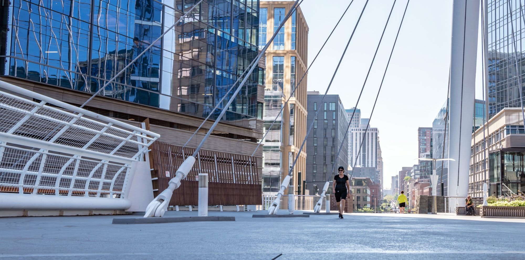 Denver, Colorado - August 28, 2021: People cross the Millennium Bridge on 16th street downtown, in the LoDo (Lower Downtown) neighborhood.