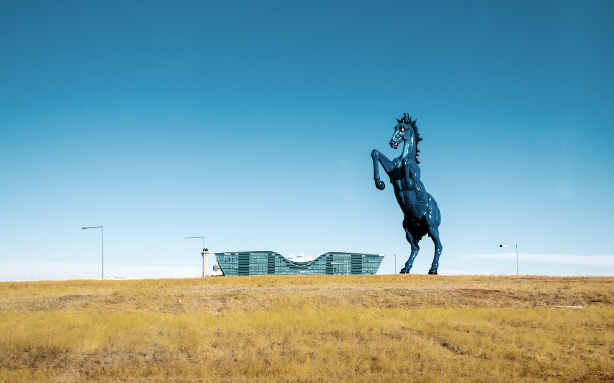 A sculpture of the symbol of Denver, the bronco, stands outside the airport.