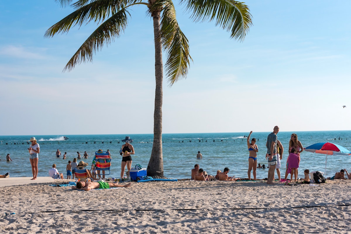 Men and women enjoy a sunny day on the sand at Higgs Beach in Key West, Florida. (January 4, 2019)