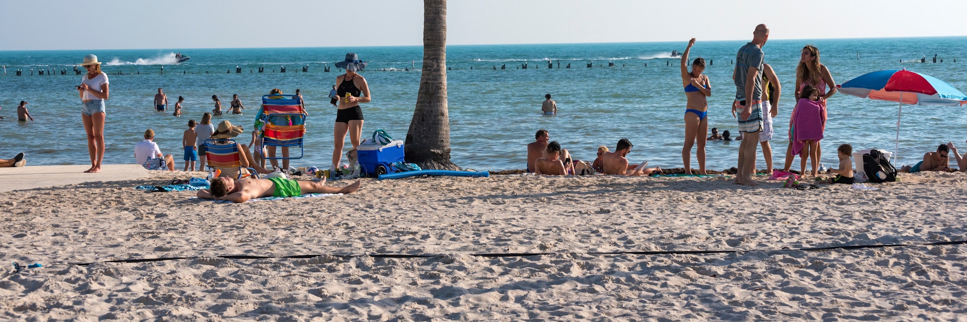Men and women enjoy a sunny day on the sand at Higgs Beach in Key West, Florida. (January 4, 2019)