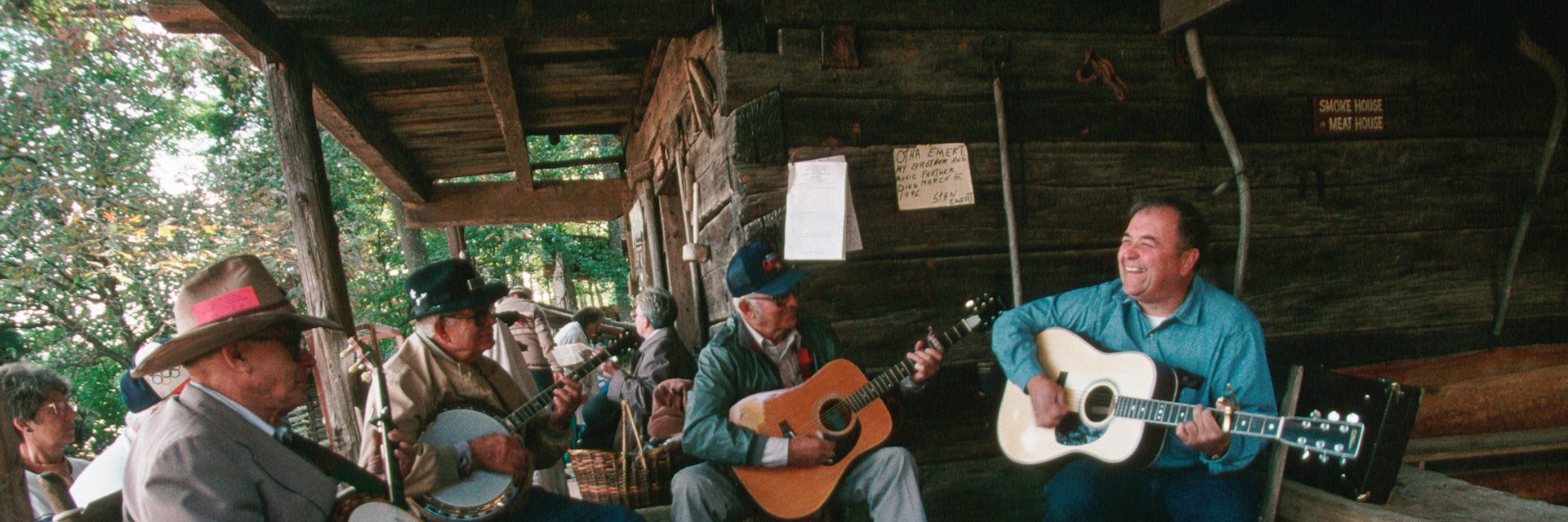 Banjoists and guitar players jam on the porch of the Museum of Appalachia during the Tennessee Fall Homecoming festival. | Location: Norris, Tennessee, USA.