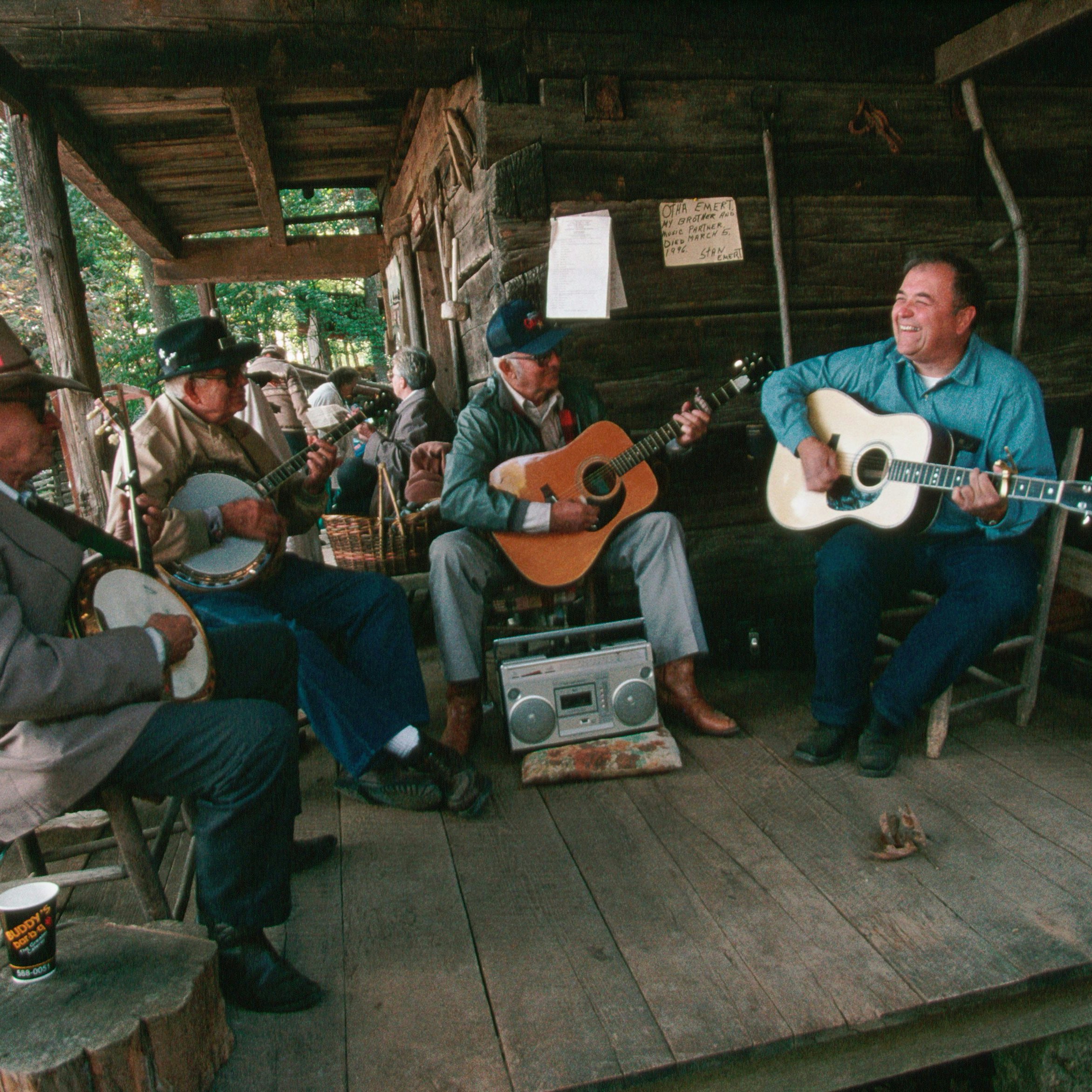 Banjoists and guitar players jam on the porch of the Museum of Appalachia during the Tennessee Fall Homecoming festival. | Location: Norris, Tennessee, USA.