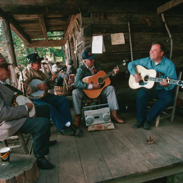 Banjoists and guitar players jam on the porch of the Museum of Appalachia during the Tennessee Fall Homecoming festival. | Location: Norris, Tennessee, USA.