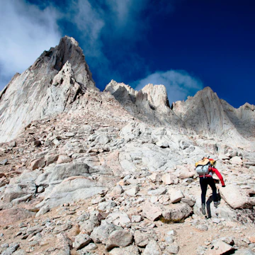 A female hiker scrambles up the mountaineer’s route of Mount Whitney, California on October 3, 2009. Mount Whitney is the highest mountain in the continental United States and stands 14,494 feet tall. Mt Whitney